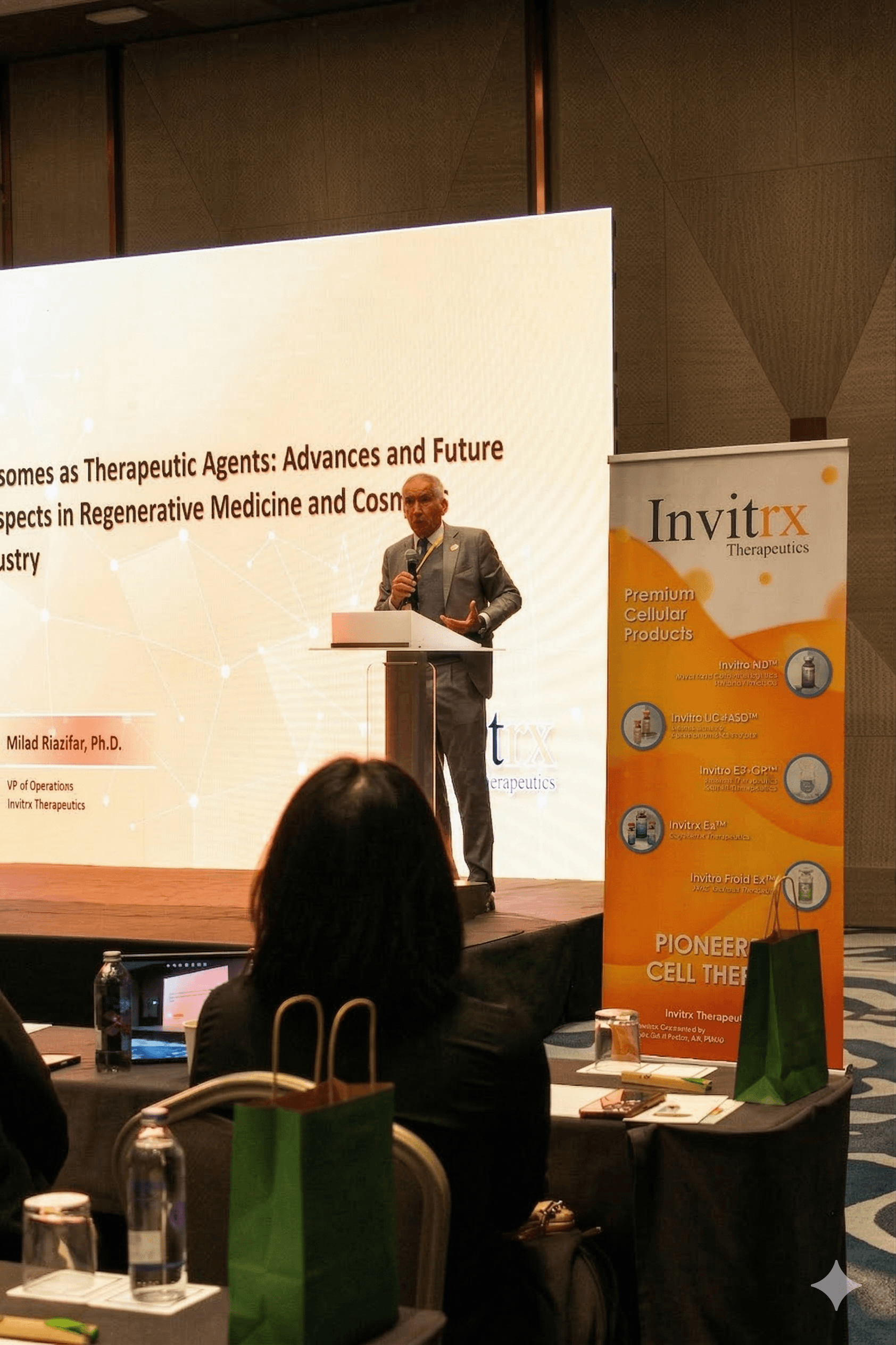 A speaker presents on regenerative medicine at a podium during an Invitrx Therapeutics conference.